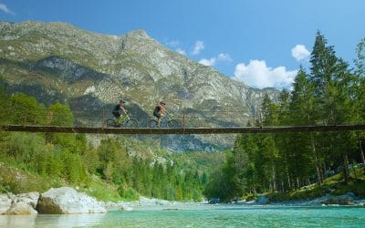 Bike tour Soča Valley bikers riding over Soča river