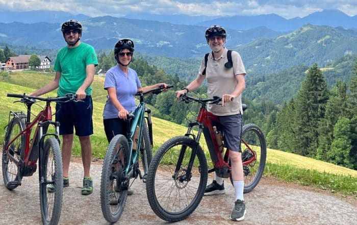 Family cycling tour in the Slovenian Alps with e-bikes and panoramic landscape