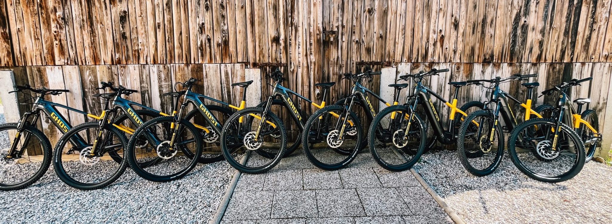 A fleet of e-bikes stands ready for adventure in Slovenia, neatly lined up and gleaming under the daylight.